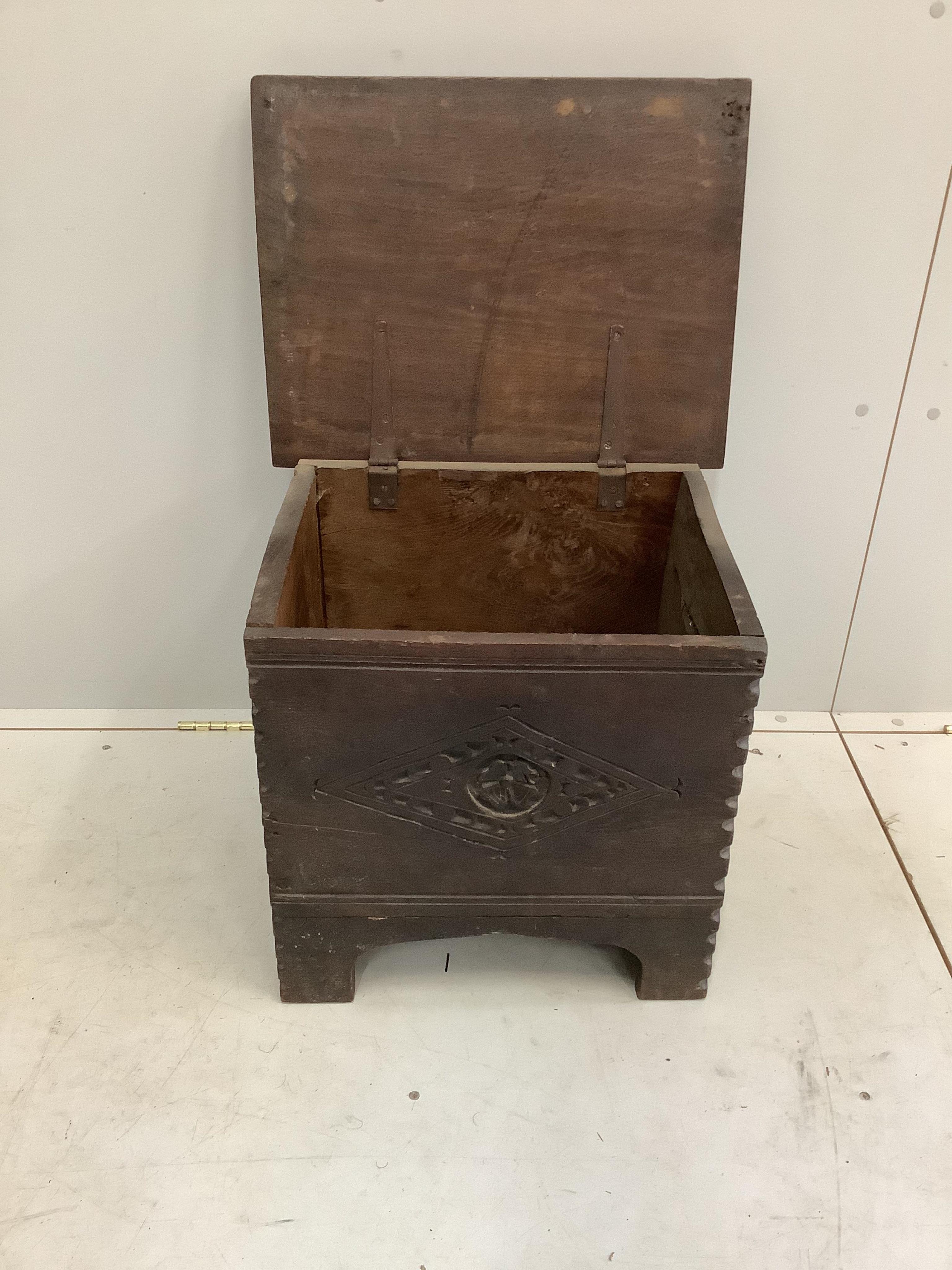 A small 17th century style carved oak coffer, width 51cm, depth 40cm, height 47cm